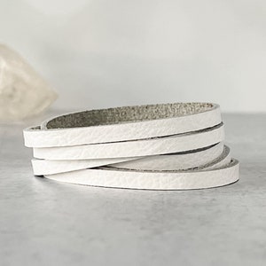 May include: White leather cord, rolled up and ready to be used for crafting projects.