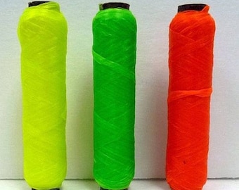 May include: Three spools of thread in vibrant colors: yellow, green, and orange. Each spool is cylindrical with a dark brown base and top. The colors are labeled with their respective names at the bottom of the image.