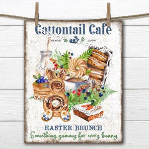 Puede incluir: Un cartel blanco con el texto "Cottontail Cafe" y "Easter Brunch Something yummy for every bunny". El cartel presenta una ilustración de acuarela de pasteles, una taza de café, arándanos y un pastel con forma de conejo.