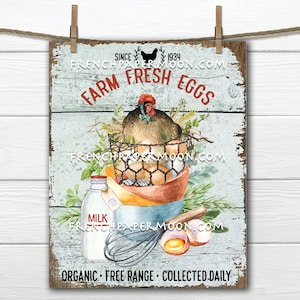 May include: A rustic wooden sign with a blue background and white painted text that reads "SINCE 1934 FRENCHPAPERMOON.COM FARM FRESH EGGS FRENCHPAPERMOON.COM ORGANIC FREE RANGE COLLECTED DAILY". The sign features a watercolor illustration of a hen in a nest with eggs, a milk bottle, a whisk, and a bowl of eggs.