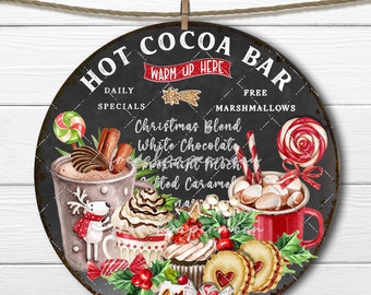 May include: A round, black chalkboard sign with white lettering that reads "Hot Cocoa Bar". The sign has a red ribbon and a wooden clothespin at the top. The sign features a variety of Christmas-themed cocoa drinks and treats, including cupcakes, cookies, and candy canes.