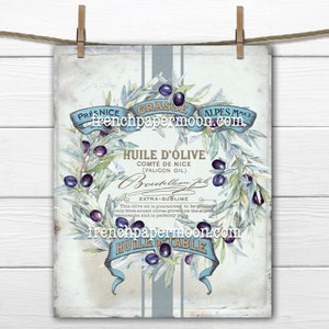 May include: A vintage label for olive oil from the French region of Nice. The label features a wreath of olive branches with olives, a blue ribbon with the text "HUILE D'OLIVE" and "COMTÉ DE NICE (FALICON OIL)", and the text "EXTRA-SUBLIME" in a decorative font. The label is on a light blue background with a white border.