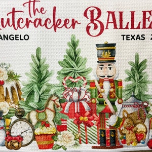 May include: A white background with the text "The Nutcracker Ballet" in red letters. The text "San Angelo Texas 2022" is below the title. The image features a nutcracker soldier, a gingerbread man, a rocking horse, a clock, a snowman, a cake, and presents. The image is decorated with green pine branches, white flowers, and red candy canes.