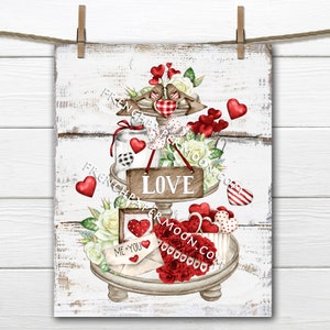 May include: A white tiered tray decorated with red hearts, flowers, and the word "LOVE". The tray is on a white wooden background.