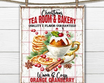 May include: A white sign with red and black text that reads "Christmas Tea Room & Bakery, Quality & Flavor Guaranteed, Warm & Cozy Orange Cranberry". The sign features a watercolor illustration of a cup of tea with a cranberry cake, orange slices, cinnamon sticks, and star anise.