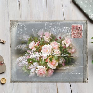May include: A vintage postcard with a faded background featuring a bouquet of pink roses and white lilac flowers. The postcard has a French stamp and the text "CARTE POSTALE" printed on it.