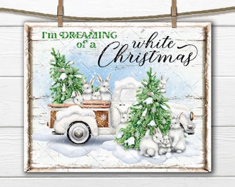 May include: A white vintage pickup truck with a white Christmas tree in the back. The truck is filled with white bunnies and the text "I'm dreaming of a white Christmas" is written on the side of the truck.