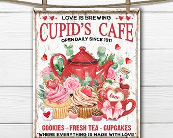 May include: A vintage-style sign for a cafe called "Cupid's Cafe" with the text "Love is Brewing" and "Open Daily Since 1911". The sign features a red teapot, pink roses, cupcakes, and cookies. The text at the bottom reads "Cookies Fresh Tea Cupcakes "Where Everything is Made With Love""