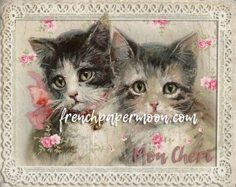 May include: Two adorable kittens with pink bows and flowers, looking at the camera. The image has a vintage feel and the text "frenchpapermoon.com" and "Mon Cheri" are visible.