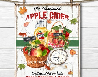 May include: A vintage-style sign advertising old-fashioned apple cider. The sign features a basket of red apples, a glass bottle of apple cider, and a scale with a clock face. The text on the sign reads "Old-Fashioned Apple Cider", "Just Picked", "254 per lb", "Delicious Hot or Cold", and "Fresh Pressed & Boiled".
