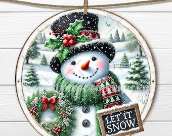 May include: A round, white-framed sign with a snowman wearing a black top hat, green scarf, and red mittens. The snowman is holding a chalkboard sign that says "Let It Snow". The background is a winter scene with snow-covered trees and a white picket fence.