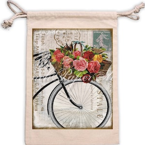 May include: A vintage-style postcard featuring a bicycle with a basket full of pink, red, and yellow roses. The postcard has a French stamp and the words "Postale" and "R&eacute;serve &agrave; l'adresse" printed on it.