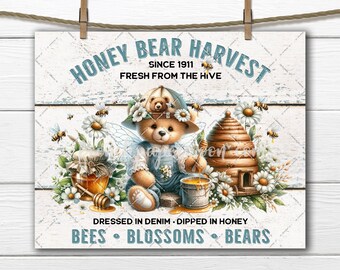 May include: A vintage-style sign with a cartoon bear wearing a blue denim outfit and a hat, holding a honey dipper over a bucket of honey. The sign reads "Honey Bear Harvest Since 1911 Fresh From The Hive" and "Dressed in Denim Dipped in Honey Bees Blossoms Bears".