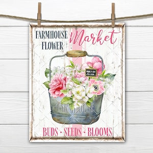 May include: A white sign with pink and gray accents reads "Farmhouse Flower Market" with a pink and white striped background. A galvanized metal bucket filled with pink and white flowers sits in the center of the sign. The sign also reads "Buds - Seeds - Blooms" in pink lettering.