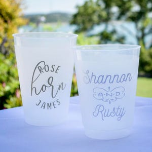 May include: Two white plastic cups with personalized text. The first cup says "Rose Horn James" and the second cup says "Shannon and Rusty".