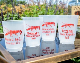 May include: Four clear plastic cups with red crawfish designs and text. The cups are labelled "Macie & Josh's Crawfish Boil", "Bobnak's Annual Crawfish Boil", "Immacolata Crawfish Boil 2017", and "Vezina Family Crawfish Boil".