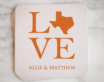 May include: A square coaster with a light beige, textured surface featuring the orange text LOVE, where the letter O is replaced by a silhouette of the state of Texas. Below the text, the names ALLIE & MATTHEW are printed in orange.