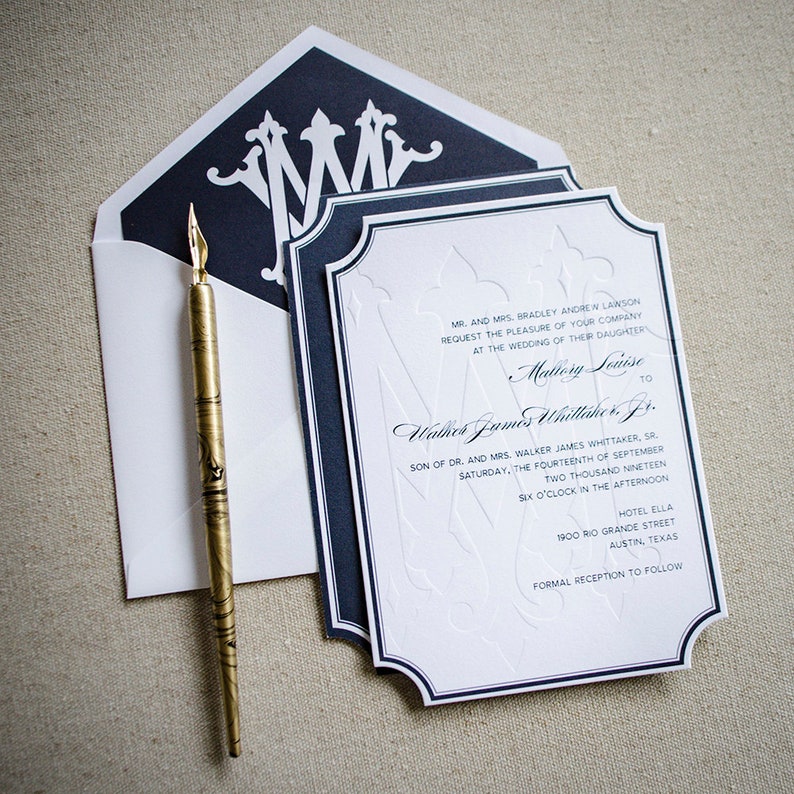 May include: A white wedding invitation with navy blue trim and a monogrammed initial "M" in the upper left corner. The invitation announces the wedding of Mallory Louise to Walker James Whittaker, Jr. on Saturday, September 14th, 2019 at 6:00 PM at Hotel Ella in Austin, Texas. A formal reception will follow.