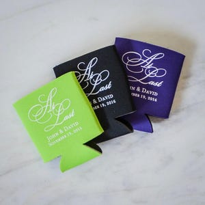 May include: Three beverage insulators in lime green, black, and purple. Each has the text "At Last" in a white script font, along with names and a date. The lime green insulator reads "John & David November 19, 2016."