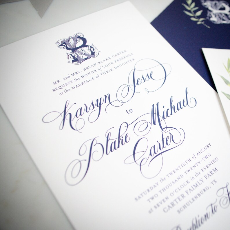 May include: Wedding invitation with a navy blue and white color scheme. The invitation features a calligraphic font and the text "MR. and MRS. BRYAN BLAKE CARTER REQUEST the HONOR of YOUR PRESENCE at the MARRIAGE of THEIR DAUGHTER Karsyn Jesse to Blake Michael Carter SATURDAY the TWENTIETH of AUGUST TWO THOUSAND TWENTY-TWO SEVEN O'CLOCK in the EVENING CARTER FAIMLY FARM SCHULENBURG, TX"