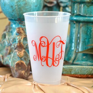 May include: A frosted plastic cup with a red monogram "MUF" in a cursive font.