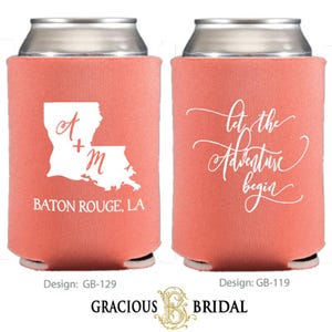 May include: Coral-colored can coolers with white text and designs. One features the Louisiana state outline with initials and "BATON ROUGE, LA." The other says "Let the Adventure begin" in cursive. The bottom of the image shows the "Gracious Bridal" logo.