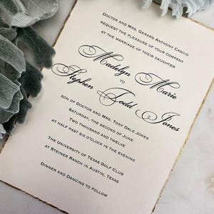 May include: Wedding invitation with gold trim, announcing the marriage of Madelyn Marie to Stephen Todd Jones. The wedding will take place on Saturday, June 2nd, 2012 at 6:30 PM at the University of Texas Golf Club at Steiner Ranch in Austin, Texas. Dinner and dancing will follow.