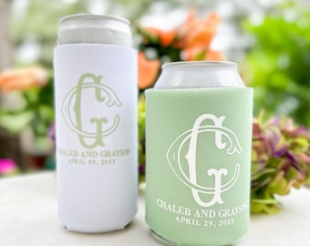 May include: Two foam can coolers, one white and one light green, each featuring a large stylized letter G monogram, the text CHALEB AND GRAYSON, and the date APRIL 29, 2023, printed in a contrasting color on the front surface.