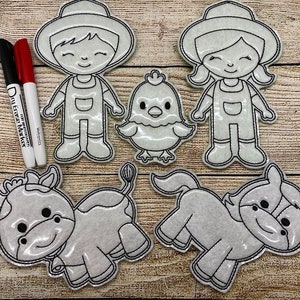 May include: A set of farm-themed felt cutouts, including a farmer, a farmerette, a chick, a cow, and a horse, all outlined in black stitching. Two dry-erase markers, one black and one red, are also included. The cutouts are designed for coloring.