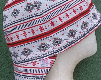 May include: A white bucket hat with a red, black, and gray geometric pattern. The hat has a label that says "Made in USA".