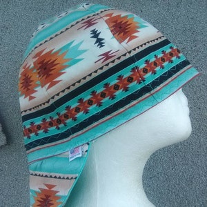 May include: A turquoise, orange, and black patterned welding cap with a "Made in USA" label.