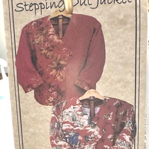 May include: A sewing pattern envelope titled Stepping Out Jacket featuring illustrations of two jackets. The top jacket has a floral pattern in shades of red and brown. The bottom jacket displays a red fabric with a detailed landscape print.