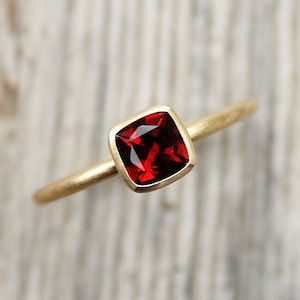 18k gold ring with garnet cushion