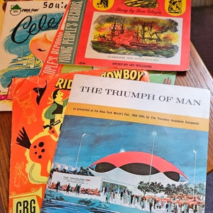 May include: A stack of five vintage children's records. The top record is red and features a picture of a ship with the title "Old Ironsides". The second record is orange and features a picture of a cowboy riding a horse with the title "Ride a Cowboy". The third record is blue and features a picture of a building with the title "The Triumph of Man". The fourth record is orange and features a picture of a horse with the title "Ride a Cowboy". The bottom record is red and features a picture of a celebration with the title "Celebrate".