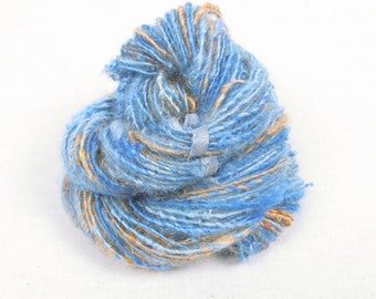 Handspun Single from Locks of 2nd Clip Kid Mohair hand dyed in shades of blue with light gold accents
