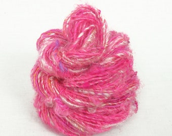 Handspun Single, from Kid Mohair dyed hot pink with natural fleece added in.