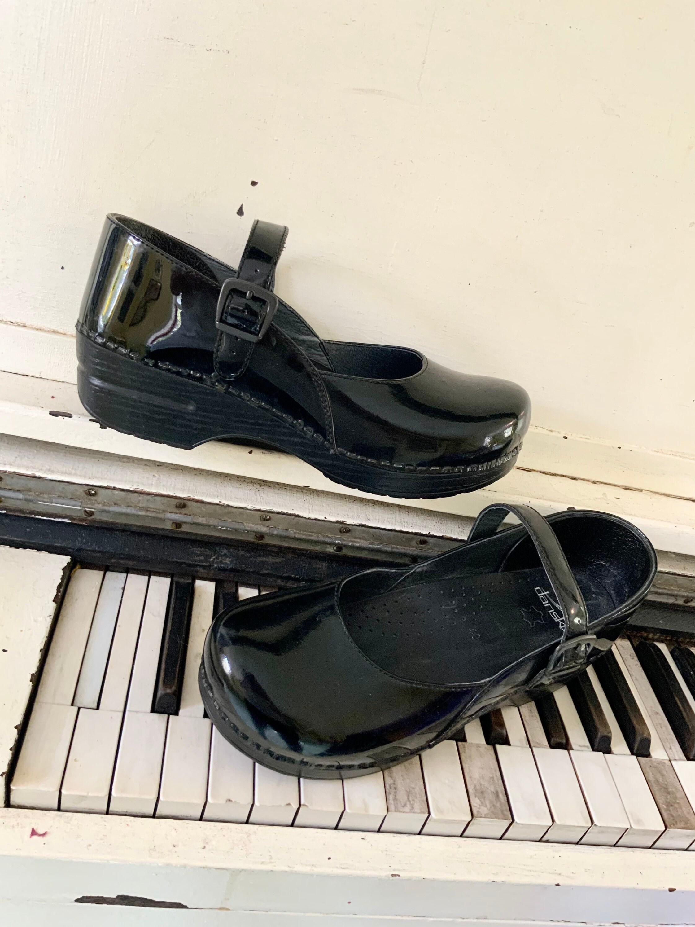 dansko black patent leather clogs