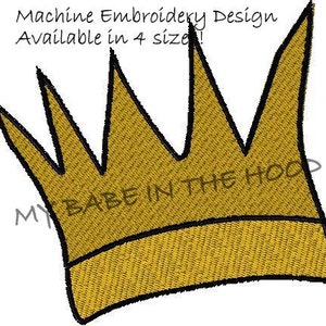 May include: A gold crown with a black outline. The crown has five points and the text "BABE IN THE HOOD" is written across the bottom.