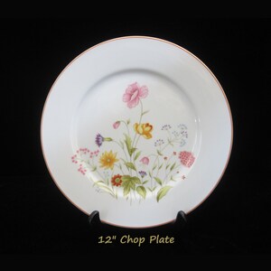 May include: A white 12-inch chop plate with a gold rim and a floral design featuring pink, yellow, and purple flowers.