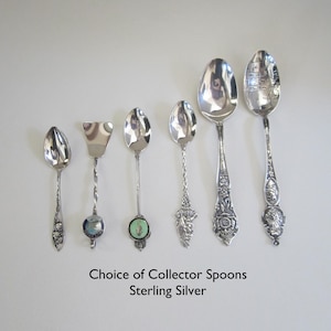 May include: A collection of six sterling silver collector spoons. The spoons feature various designs and are displayed on a white background.  Choice of Collector Spoons Sterling Silver