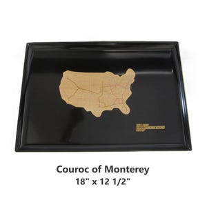 May include: A rectangular black tray with a gold-colored map of the United States in the center. The tray measures 18 inches by 12.5 inches. The text "Courroc of Monterey" and "William Communications Group" are also visible.