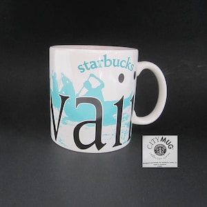 May include: White ceramic mug with a black Starbucks logo and the word "Waikiki" in black lettering. The mug has a blue and white image of a beach scene with people surfing. The mug has a black City Mug collector series label.