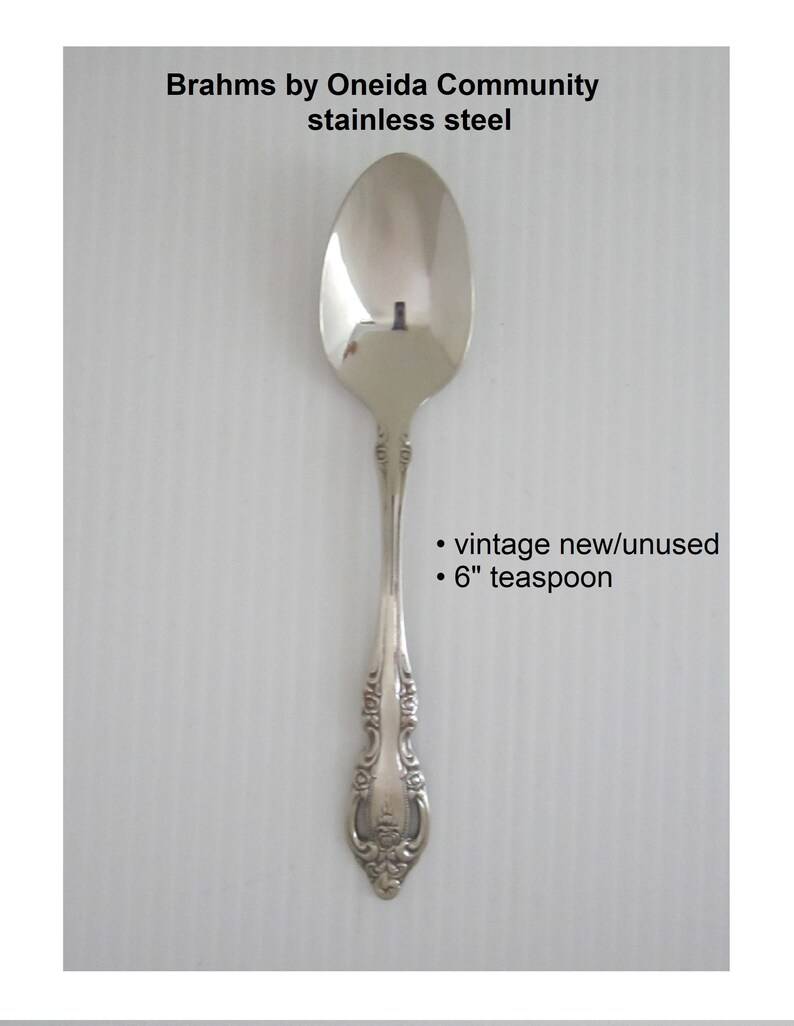 May include: A silver teaspoon with an ornate handle. The spoon is 6 inches long and is vintage but new and unused.