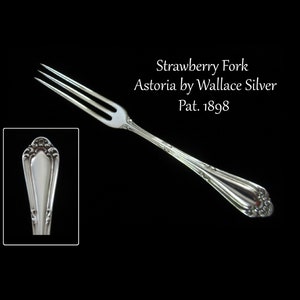 May include: Silver strawberry fork with an ornate handle. The fork is marked "Astoria by Wallace Silver" and "Pat. 1898".