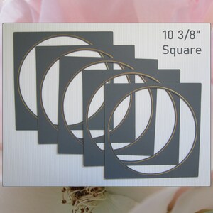 May include: Set of six gray square die-cut frames with gold inner circles. Each frame measures 10 3/8 inches square.