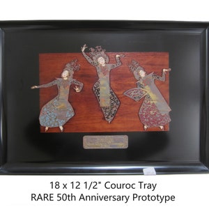 May include: A black framed tray with a wooden inlay featuring three cutout figures of dancers. The tray is 18 inches by 12 1/2 inches and is a rare 50th anniversary prototype.