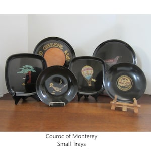 May include: Set of six black lacquer trays with various designs, including a hot air balloon, a bird, a tree, and the words "Cheese and Crackers".