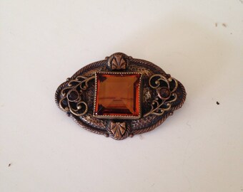 Wonderful old brooch with gold glass stone and great detail