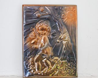 May include: A copper wall plaque with a raised relief design of a child holding a bird and a deer in a forest setting. The plaque has a brown and gold patina and is set against a white background.