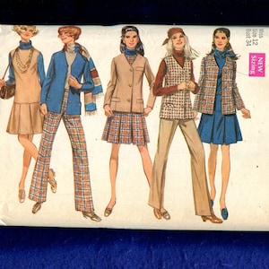 May include: Vintage Simplicity sewing pattern envelope featuring illustrations of women in 1970s fashion. The designs include coats, skirts, pants, and dresses in various colors and patterns. The envelope is green and white with the pattern number 8356.